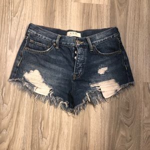 Free People distressed denim shorts.